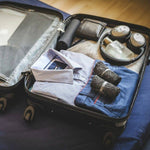 DIRTS Black Barefoot Sock Shoes packed in suitcase