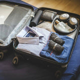 DIRTS Black Barefoot Sock Shoes packed in suitcase