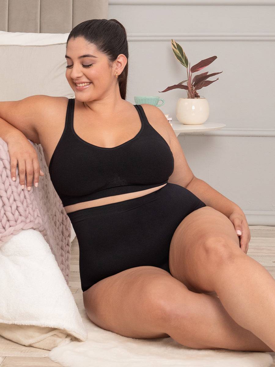 Woman in black shaper panty relaxing comfortably