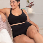 Woman in black shaper panty relaxing comfortably