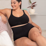 Woman in black shaper panty relaxing comfortably